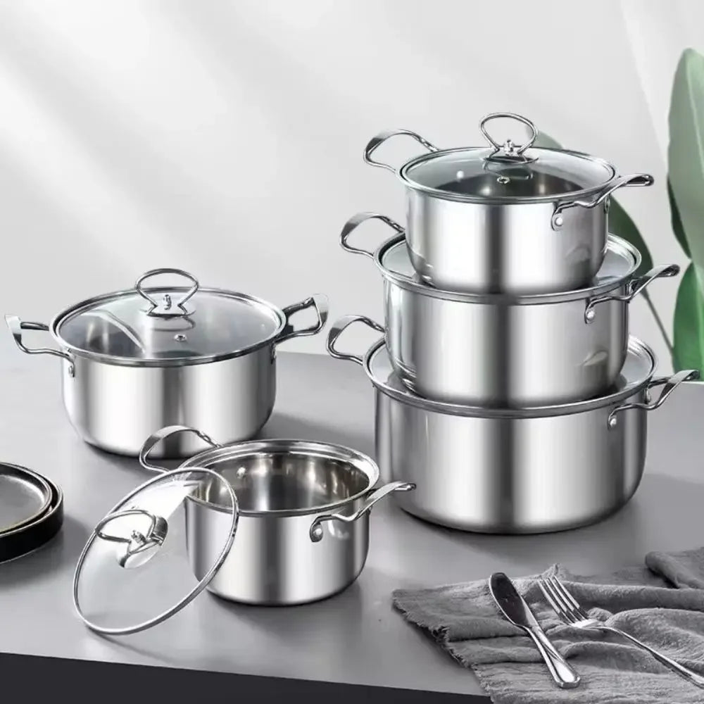 Stainless steel cookware set with glass lids on grey kitchen counter, Stel plastic-free kitchenware